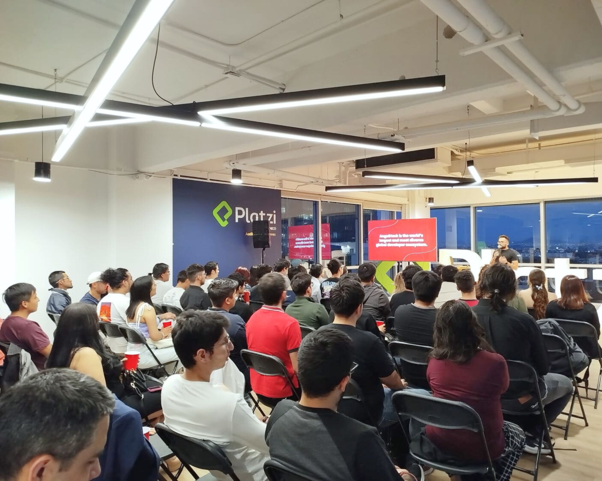 Aaron speaking to a packed AngelHack x Platzi developer audience in Mexico City